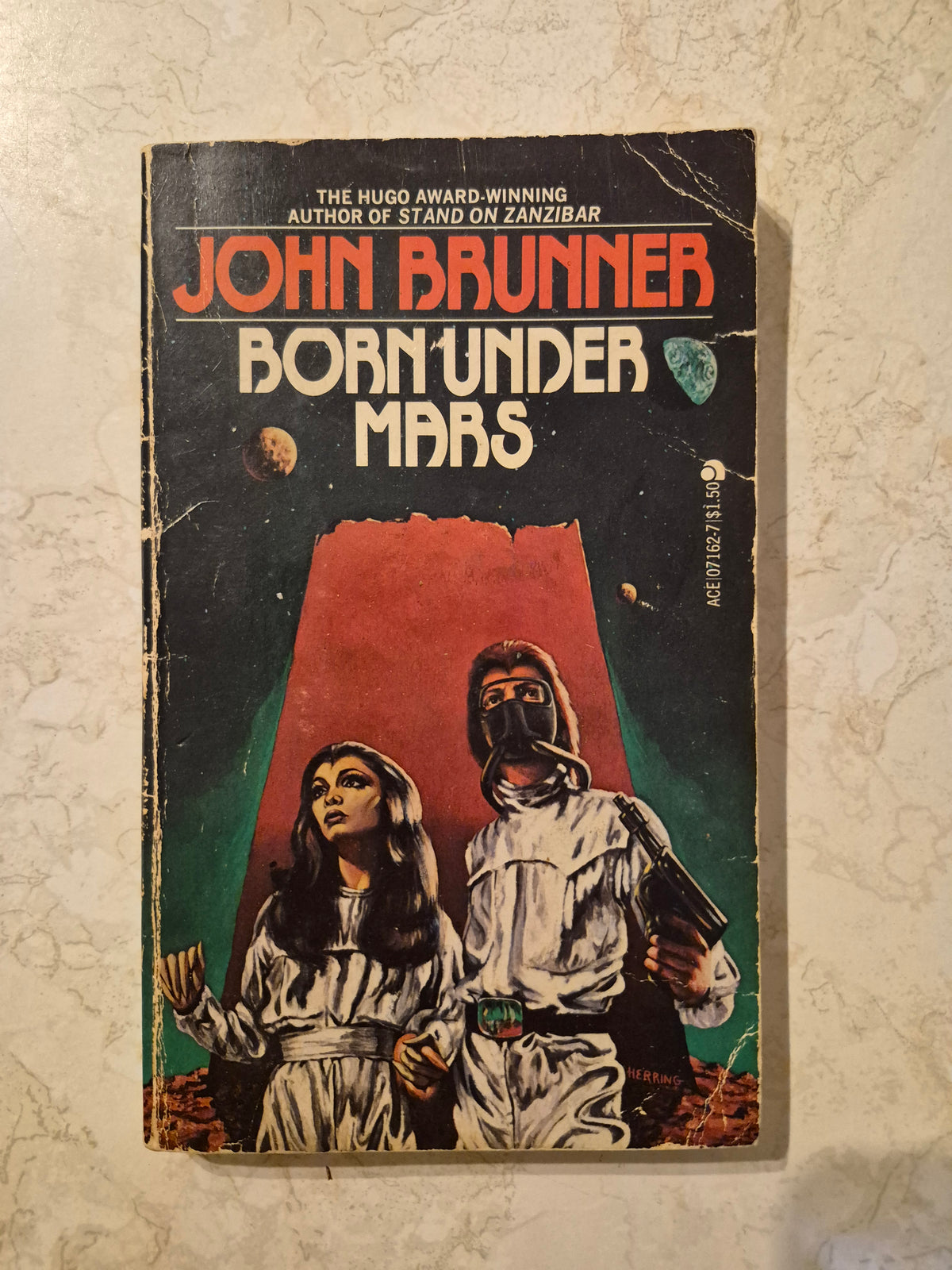 Front cover of Born Under Mars by John Brunner showing creases and edge wear