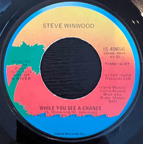 Steve Winwood : While You See A Chance / Vacant Chair (7", Single, Jac)