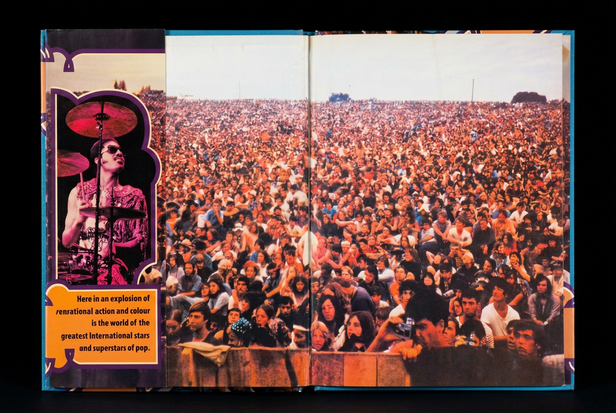 Story of Pop open book upright with original dust jacket flap on the left against a solid black background